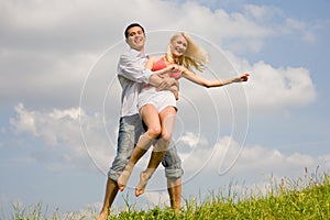 Happy Young love Couple - jumping under sky