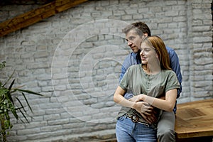 Happy young lovely couple in the kitchen hugging each other