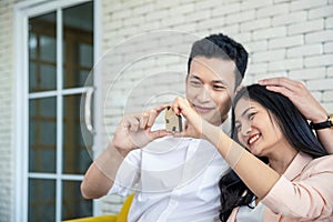 Happy young loving couple talking to their real estate agent with smile looking at house , Planning for the future of the family