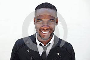 Happy young male fashion model in leather jacket and tie