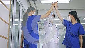 Happy and young male and female Asian team of doctor and nurse wearing uniform and lab coat with stethoscope and