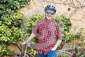 Happy Young Male hold bycycle background green