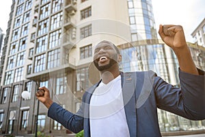 Happy young male worker enjoying victory