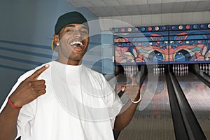 Happy Young Man At Bowling Alley