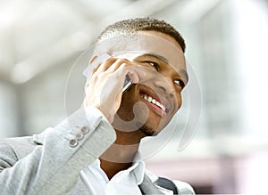 Happy young man calling by mobile phone