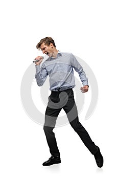 Happy young man dancing in casual clothes or suit, remaking legendary moves of celebrity from culture history