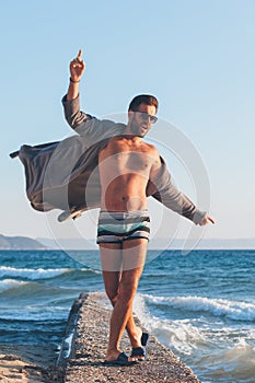 Happy young man dancing on the dock