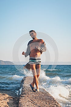 Happy young man dancing on the dock