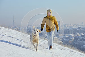 Happy young man with dog in winter