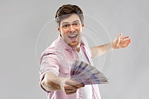 Happy young man with fan of euro money