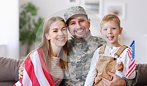 Happy young man father in military uniform reunited with his beautiful american family