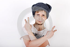 Happy young man in grey cap with earflaps