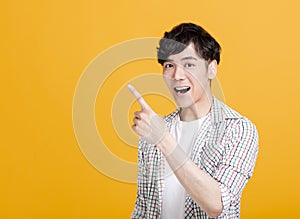 Happy young  man hand pointing to something