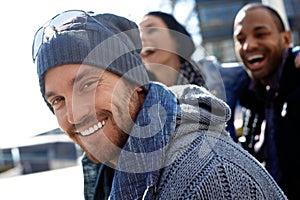 Happy young man in hat and scarf