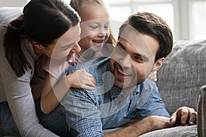 Happy young man having fun with wife and adorable child.