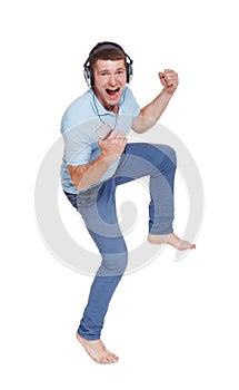 Happy young man with headphones sing, dance, enjoy music