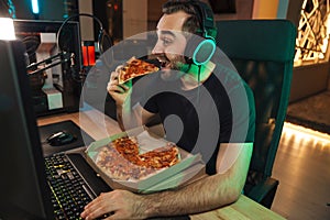 Happy young man in headset with pc computer