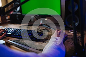 Happy young man in headset with pc computer playing game at home and streaming playthrough. Technology, gaming photo