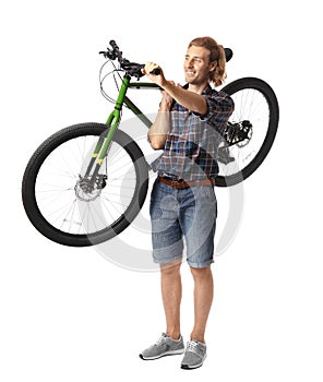 Happy young man holding bicycle on background