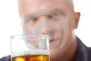 Happy young man holding a glass of beer