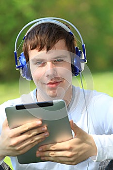 Happy young man holding an ipad