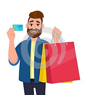 Happy young man holding shopping bags. Male character showing a credit, debit, ATM, bank card in hand. Modern lifestyle, digital.