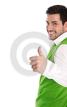 Happy young man isolated in a green shirt and thumbs up.