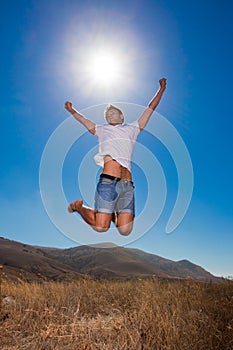 Happy young man jump in the mountains