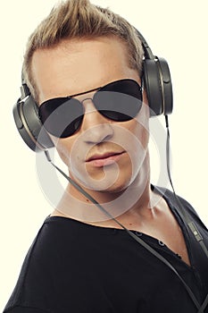 Happy young man listening to music with headphones