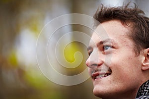 Happy young man looking up at copyspace