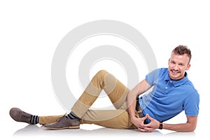 Happy young man lying on the floor