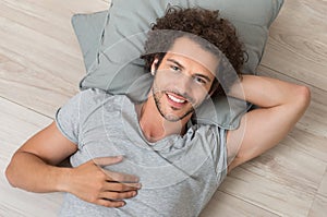 Happy Young Man Lying On Floor