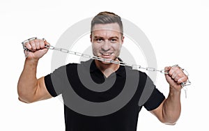 Happy young man with metal chain on isolated white background. Sporty handsome man with iron chain.