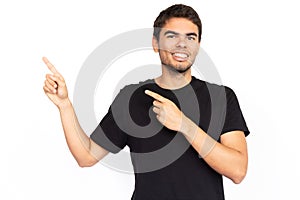 Happy young man pointing finger at ads