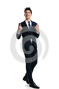 happy young man pointing finger up to the sky and walking