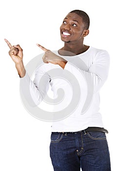 Happy young man pointing at something