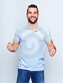 Happy young man in polo shirt