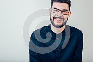 Happy young man. Portrait of handsome young man keeping arms crossed and smiling