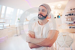 Happy young man. Portrait of handsome young man in casual shirt and keeping arms crossed and smiling while standing