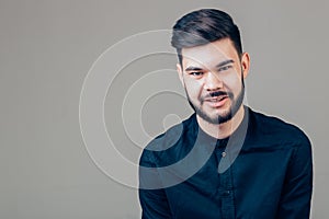 Happy young man. Portrait of handsome young man keeping arms crossed and smiling