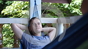 Happy, young man relaxing in hammock outdoor , slow motion 240fps