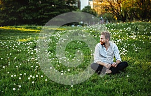 Happy young man rest on meadow. Nature, people concept