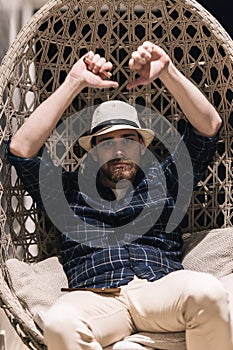 Happy young man resting in a hammock at home after work. Lifestyle concept