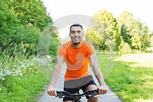 Happy young man riding bicycle outdoors