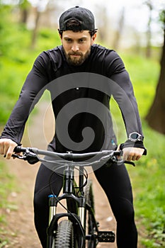 Happy young man is riding bicycle outside. Healthy Lifestyle