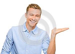 Happy young man showing empty copyspace on white background photo