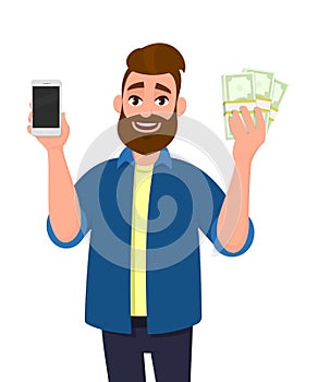 Happy young man showing or holding a mobile, cell, smart phone and bunch of cash, money, dollar, currency, bank notes in hand.