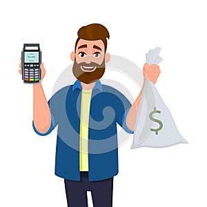 Happy young man is showing or holding money bag, cash bag and POS terminal or credit, debit card swiping payment machine in hand.