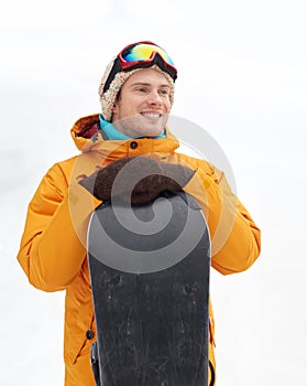 Happy young man in ski goggles outdoors