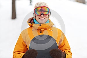 Happy young man in ski goggles outdoors